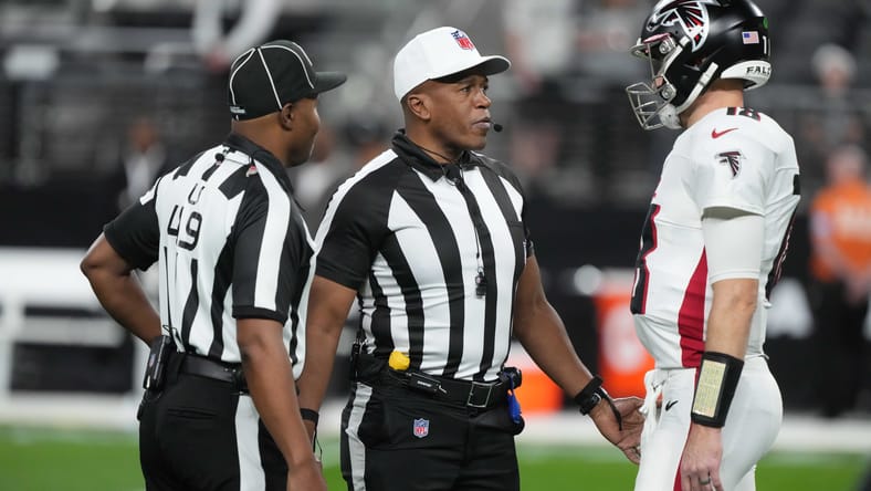 Kirk Cousins talks with officials during a game at Allegiant Stadium.