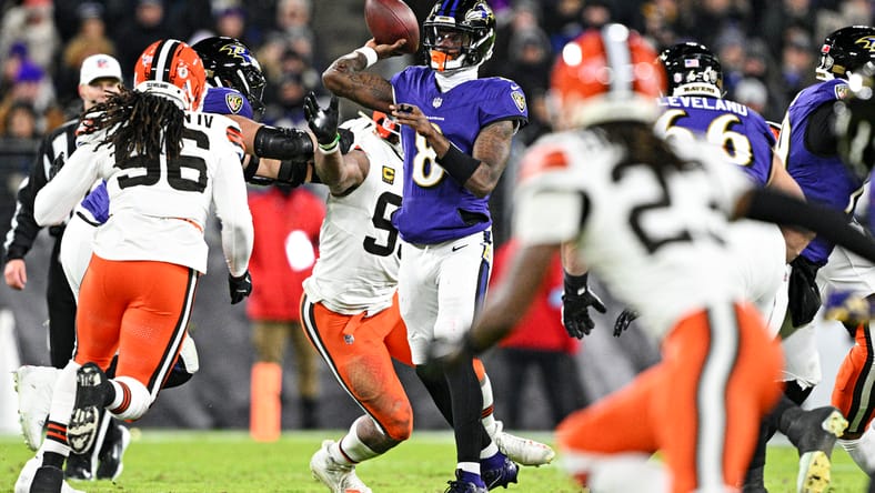 Zay Flowers throws while James Houston defends in January 2025