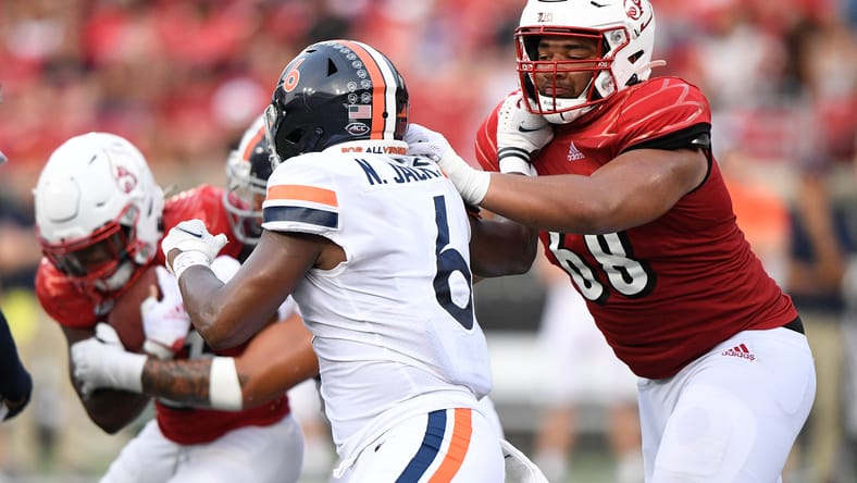 Michael Gonzalez blocks Nick Jackson during Louisville vs Virginia game.
