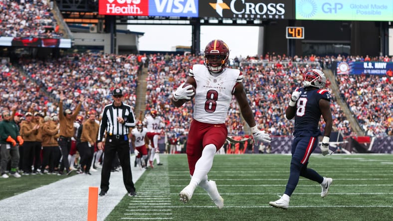 Brian Robinson Jr. runs for a touchdown against Patriots.