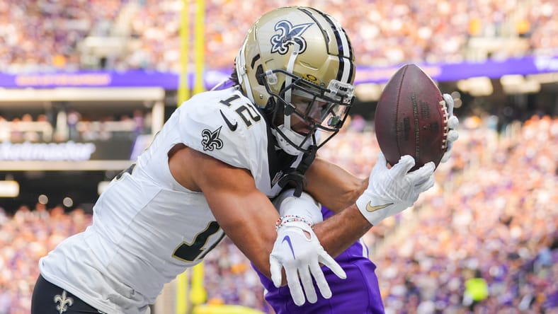 Saints wide receiver Chris Olave catches a touchdown against the Vikings in 2023.