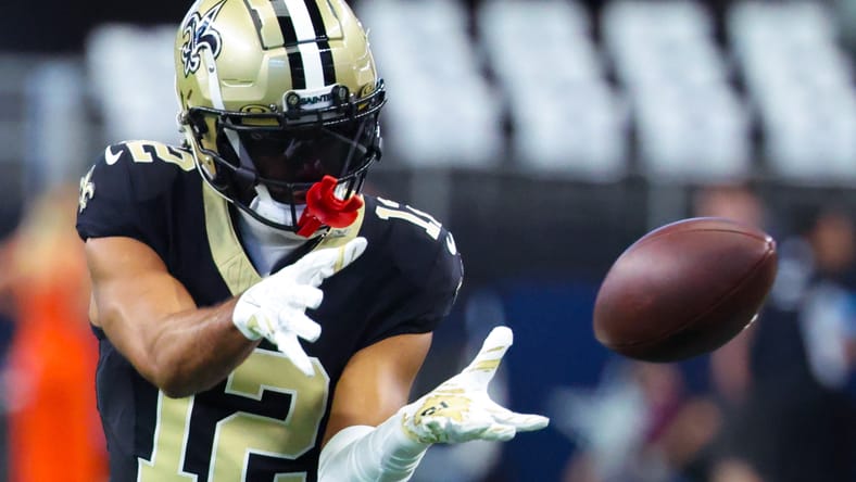 Saints wide receiver Chris Olave warms up before facing the Cowboys in 2024.