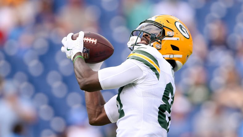 Romeo Doubs makes a pregame catch during warmups against the Titans.