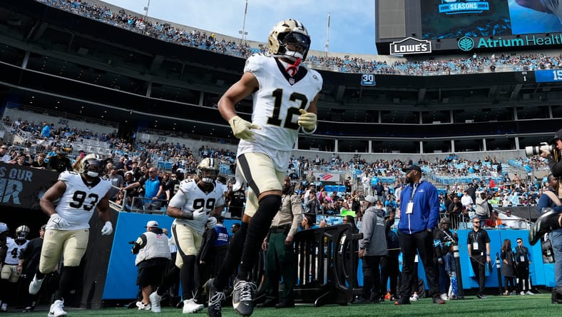 Saints wide receiver Chris Olave runs onto the field in Charlotte in 2024.