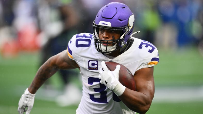 C.J. Ham runs the ball for the Vikings against the Seahawks in 2024.