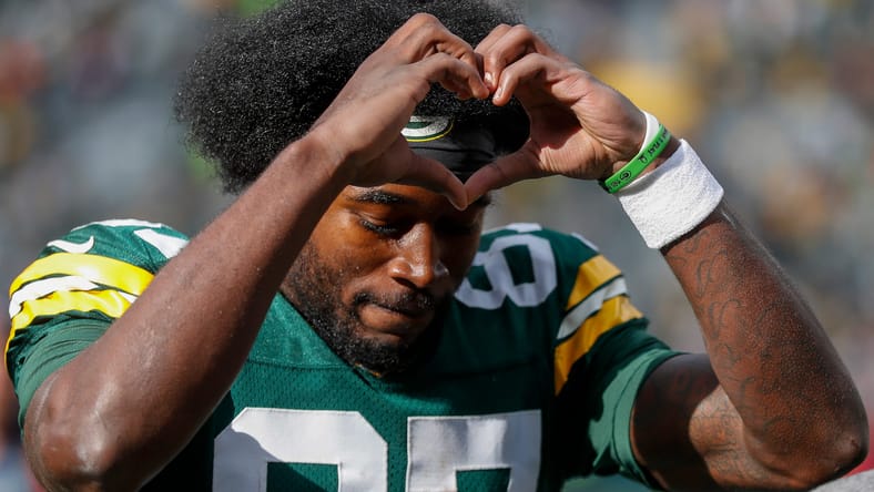 Romeo Doubs flashes a heart to fans after a win over the Cardinals.