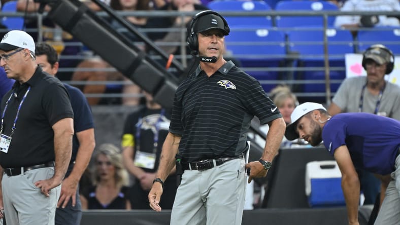 Ravens head coach John Harbaugh looks on from sideline.