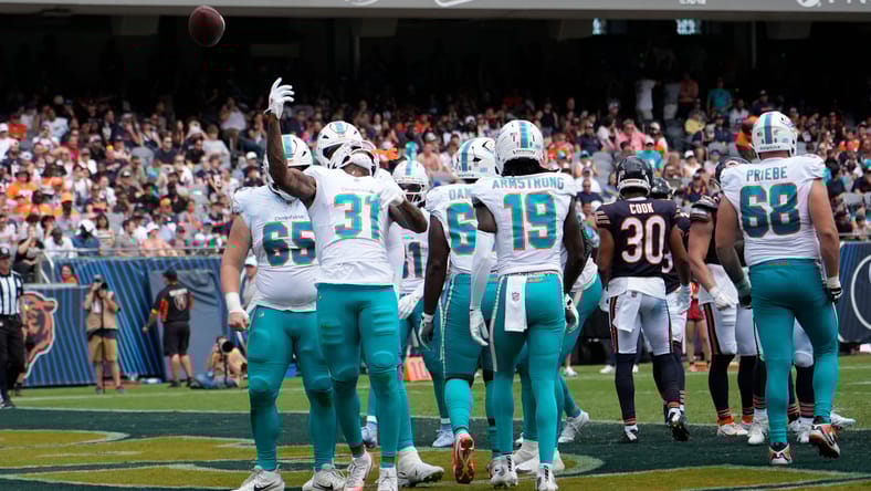 Ollie Gordon II celebrates touchdown vs Bears at Soldier Field.