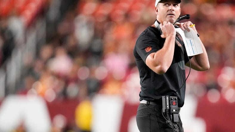 Bengals coach Zac Taylor watches replay during preseason game vs. Commanders.