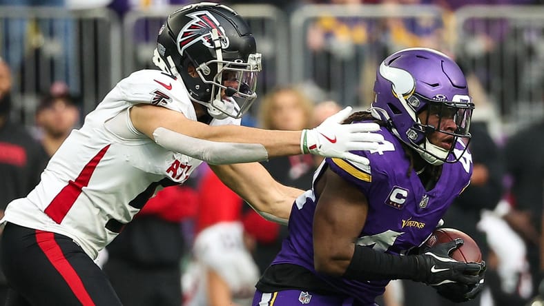 Vikings safety Josh Metellus and Falcons WR Drake London in 2024.