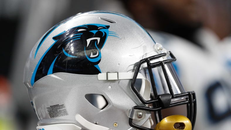 Carolina Panthers helmet sits near the sideline bench during game against the Detroit Lions at Ford Field. Jonathan Greenard trade