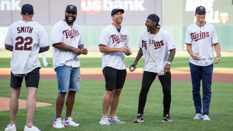 Vikings players throw ceremonial first pitch at Target Field.