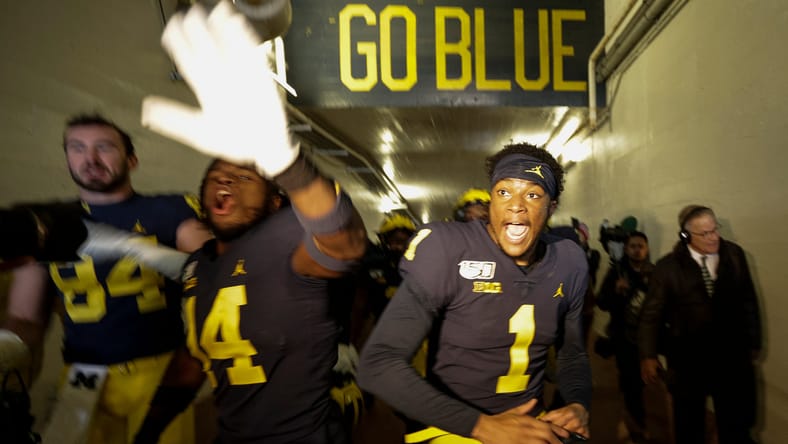 Sean McKeon, Josh Metellus, and Ambry Thomas celebrate Michigan win over MSU.