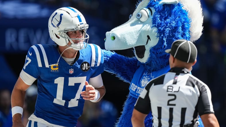 Daniel Jones celebrates a touchdown with Colts mascot Blue during the win over Miami.