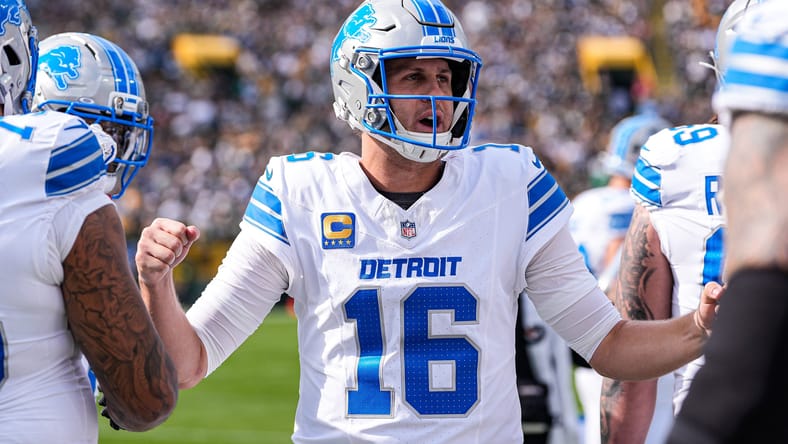 Jared Goff encourages teammates from the Lions sideline during their Week 1 matchup at Lambeau Field.