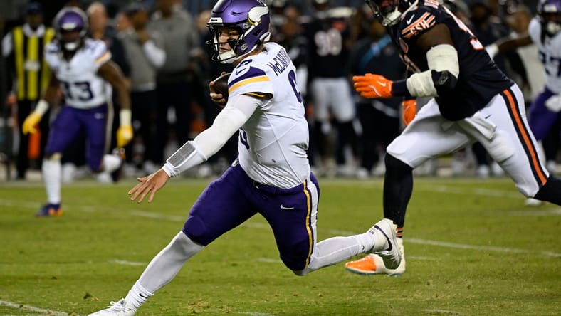J.J. McCarthy runs the ball in the first half against the Bears.