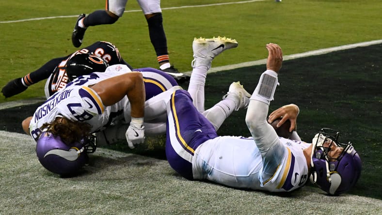J.J. McCarthy scores a rushing touchdown against the Bears at Soldier Field.
