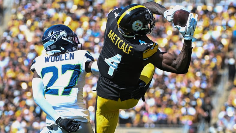 DK Metcalf makes a contested catch over Riq Woolen.