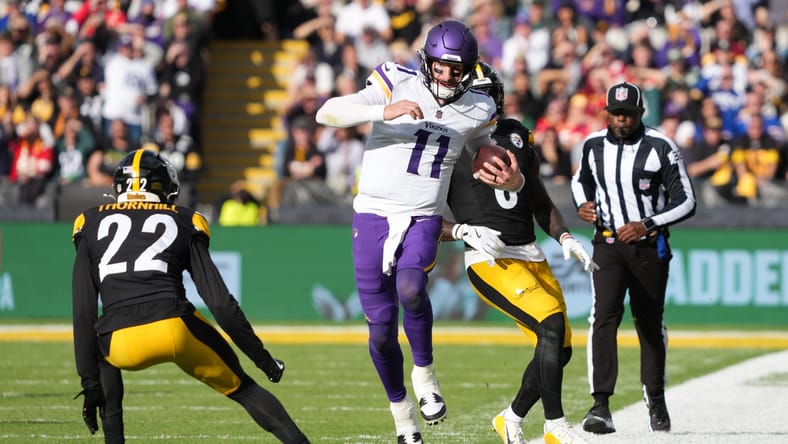 Carson Wentz runs for gain past Steelers defender in Dublin.