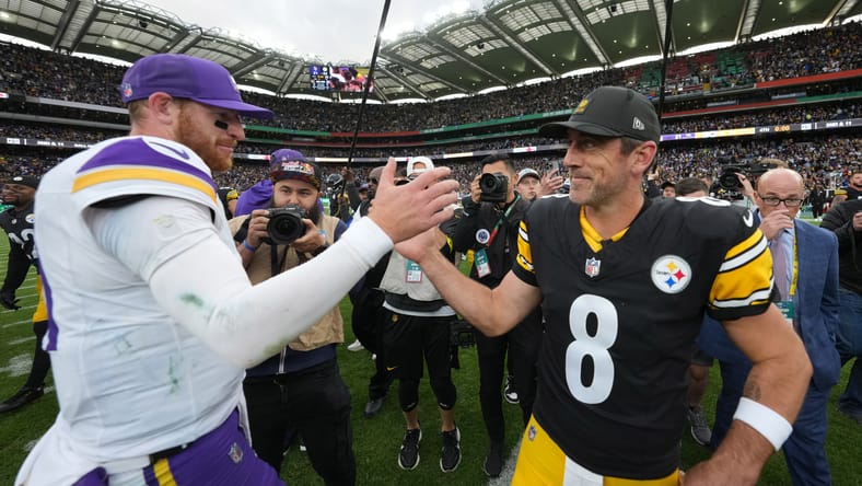 Carson Wentz and Aaron Rodgers shake hands after Vikings-Steelers game in Dublin.