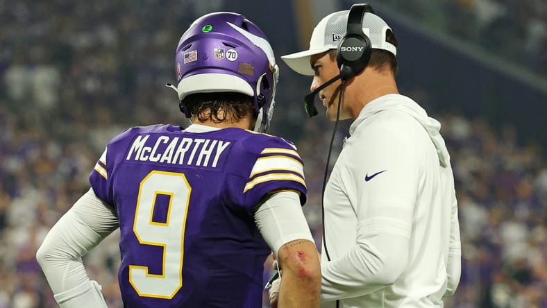 J.J. McCarthy talks with Kevin O’Connell on the Vikings sideline during the game against the Falcons.