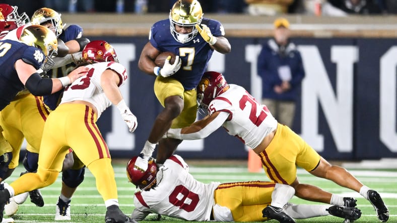 Audric Estime hurdles USC defenders during Notre Dame’s win at Notre Dame Stadium.