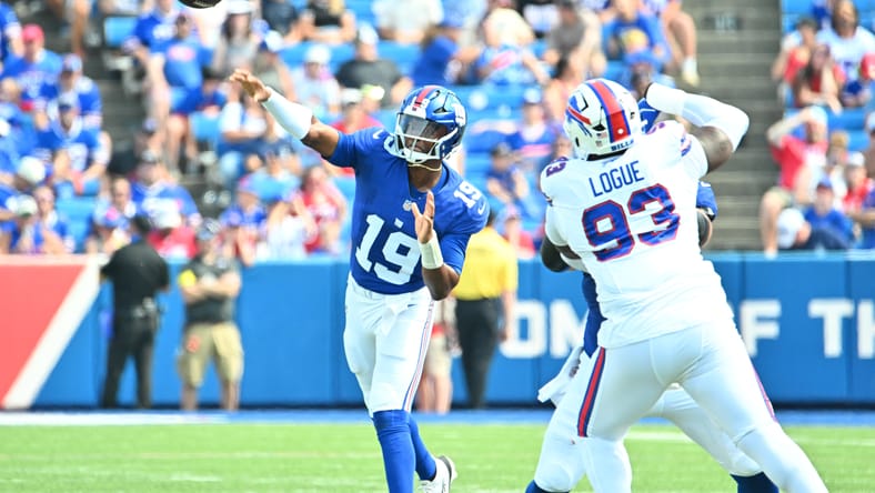 Jameis Winston throws a pass under pressure from a Bills defender during a preseason game at Highmark Stadium.