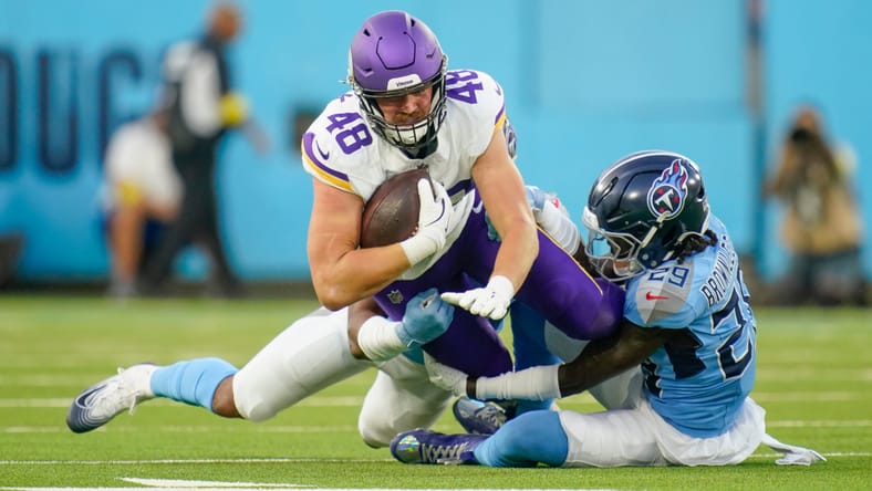 Cedric Gray and Jarvis Brownlee Jr. tackle Vikings tight end Ben Yurosek.