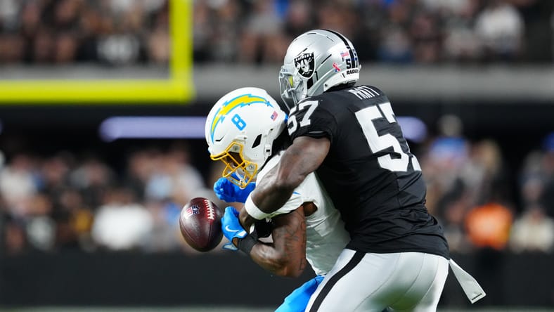 Germaine Pratt defends pass against Chargers running back Omarion Hampton.