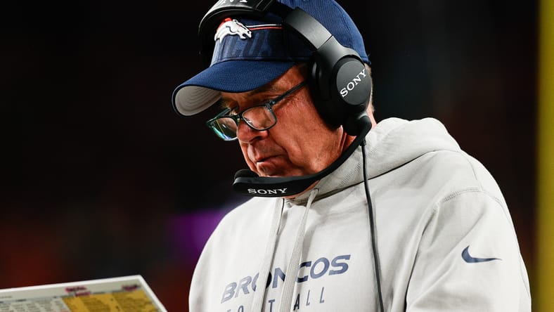 Sean Payton studies his notes during the Broncos’ game against the Bengals at Empower Field at Mile High.
