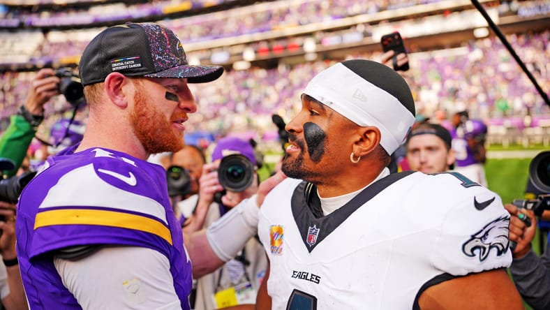 Carson Wentz and Jalen Hurts talk after the Vikings’ home game against the Eagles at U.S. Bank Stadium.