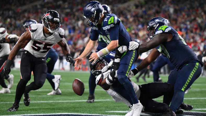 Will Anderson Jr. forces a fumble on Sam Darnold in the end zone during Texans-Seahawks action at Lumen Field.