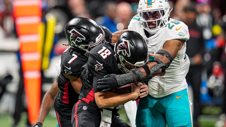 Jordyn Brooks sacks Kirk Cousins during the first half of the Falcons vs. Dolphins game in Atlanta.