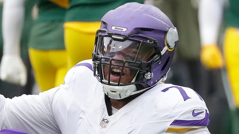 Micah Parsons helps Christian Darrisaw off the ground at Lambeau Field.