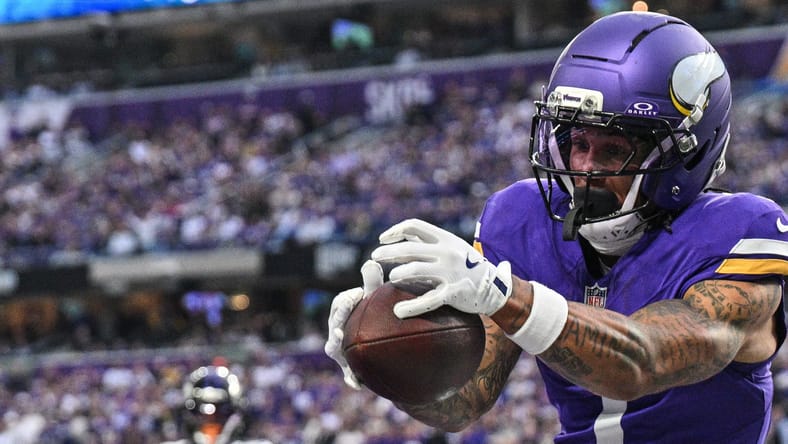 Jalen Nailor grabs a fourth-quarter touchdown while covered by Nate Wiggins during the Vikings-Ravens game.