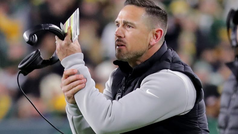 Matt LaFleur gestures to officials during Packers–Bears action at Lambeau Field.