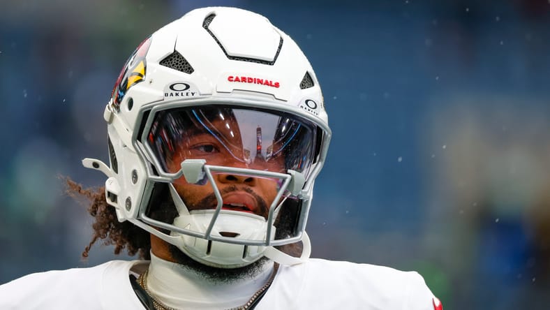 Kyler Murray stretches and throws during pregame warmups before the Cardinals’ road matchup with the Seahawks.