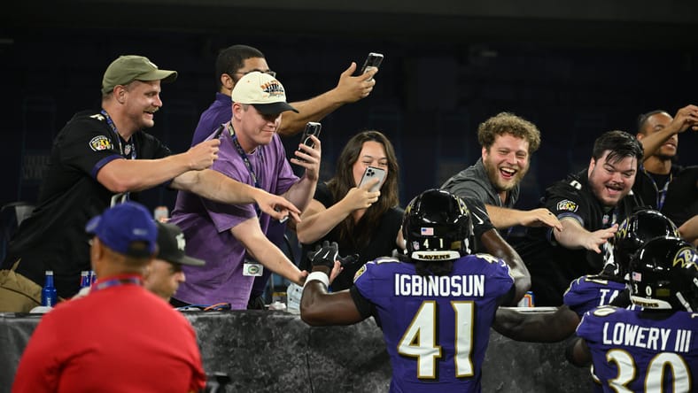 Desmond Igbinosun celebrates with Ravens fans after an interception vs. Colts.