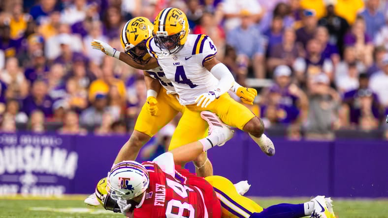 Mansoor Delane is tackled by Eli Finley during LSU–Louisiana Tech.