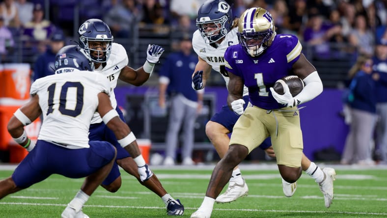 Jonah Coleman rushes in the first quarter against UC Davis during Washington’s home opener at Husky Stadium.