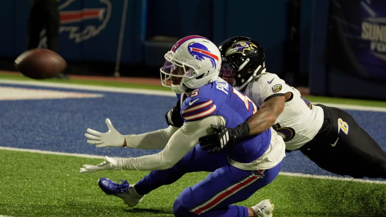 Ravens cornerback Jaire Alexander is flagged for holding Bills receiver Joshua Palmer during a pass attempt at Highmark Stadium.