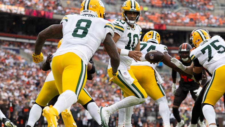 Jordan Love prepares to hand off to Josh Jacobs near the goal line versus Cleveland.