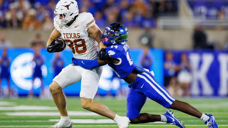 Jack Endries is tackled by Ty Bryant at Kroger Field.