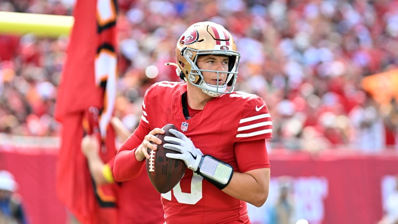Mac Jones warms up before the 49ers face the Buccaneers.