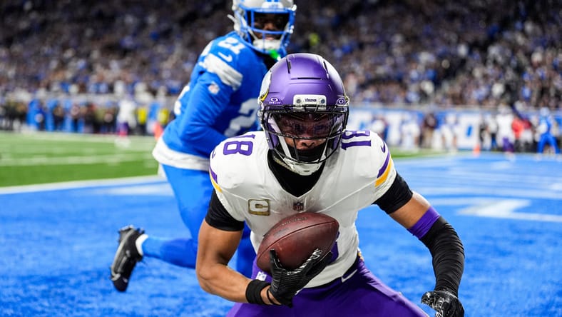 Justin Jefferson catches a touchdown over Lions cornerback Amik Robertson during the first half at Ford Field.