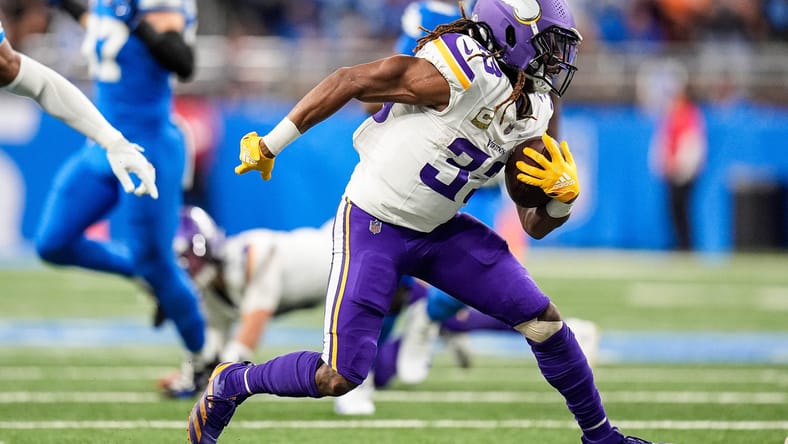 Aaron Jones Sr. runs the ball against the Lions during first-half action at Ford Field.