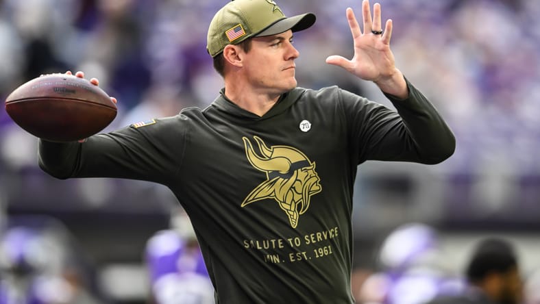 Kevin O’Connell warms up with players before facing Baltimore.