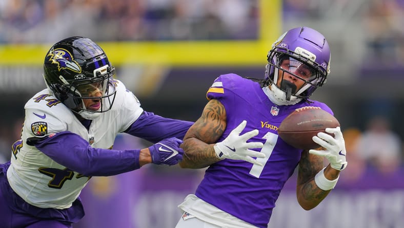 Jalen Nailor makes a first-quarter catch while defended by Marlon Humphrey at U.S. Bank Stadium.