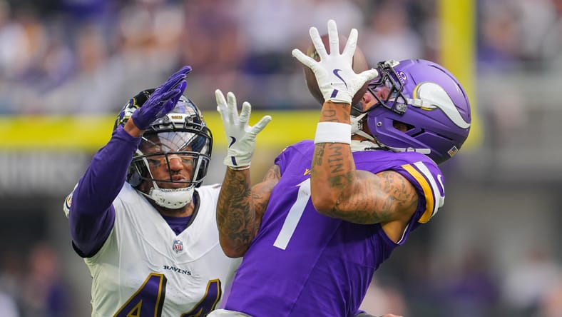 Jalen Nailor catches a pass while defended by Marlon Humphrey during a Vikings home game.