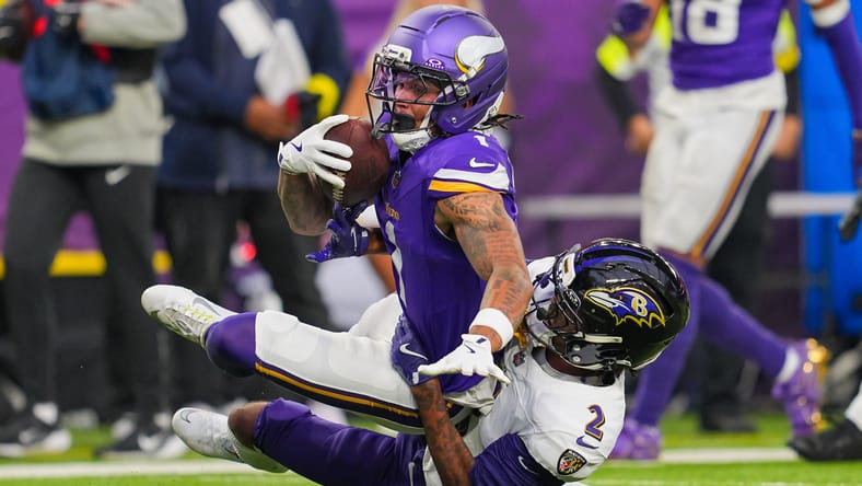 Jalen Nailor makes a catch while defended by Nate Wiggins late in the Vikings-Ravens game.
